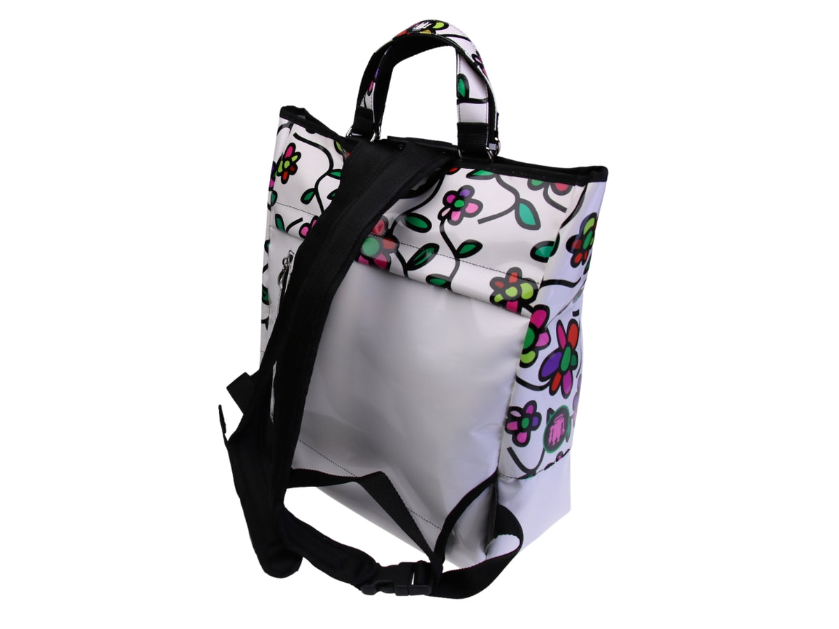 ...2 IN 1 BRIEFCASE AND BACKPACK IN WHITE COLOUR WITH FLORAL FANTASY. MODEL HYBRID MADE OF LORRY TARPAULIN.